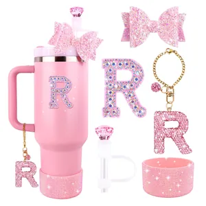 Pink tumbler accessories set featuring glittery bow straw covers and letter R charms