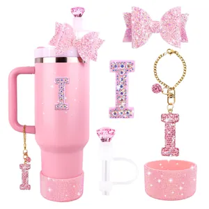 Pink tumbler accessories set featuring glitter bow straw topper and rhinestone letter charms