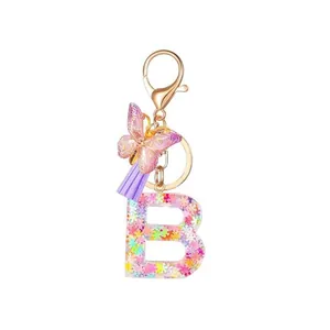 Glittering resin letter B keychain with purple butterfly and fiber tassel for women