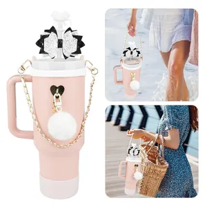 Pink 40oz vacuum tumbler with bow straw cover, pompom charm, and gold chain accessory