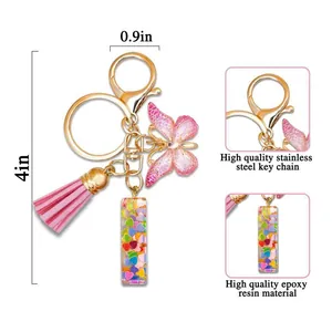 Pink resin letter keychain with butterfly charm and tassel on a stainless steel ring