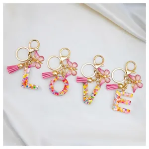 Resin initial keychain set LOVE with floral patterns, butterfly charms and tassels