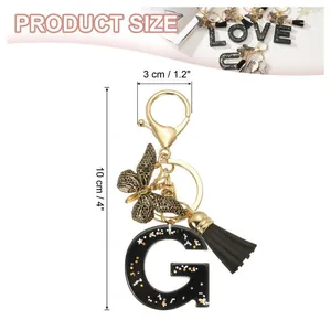 Porte-clés lettre G en résine à paillettes noires avec papillon et pompon en cuir