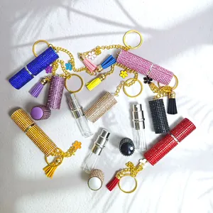 Detailed view of colorful rhinestone perfume bottle keychains with tassel accents