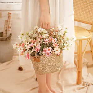 Handwoven wicker basket with five-head artificial daisies for rustic home decoration