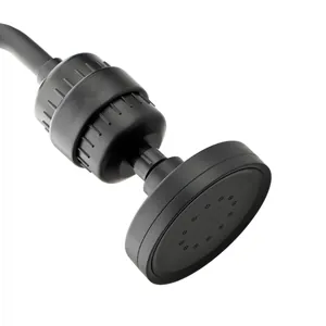 Detail view of matte black shower head featuring filtration system and spray nozzles