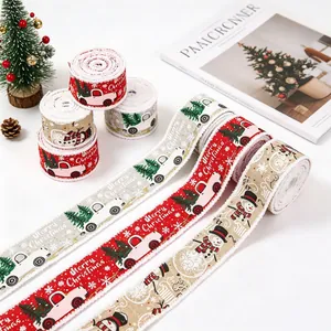 Detailed view of Christmas ribbons featuring snowmen and red truck patterns on linen texture
