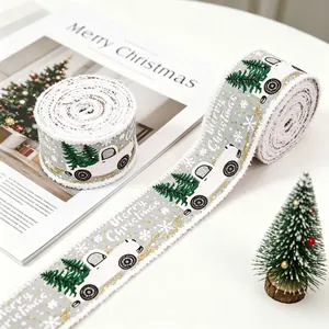 Close-up of Merry Christmas ribbons with truck and tree patterns and frayed edges