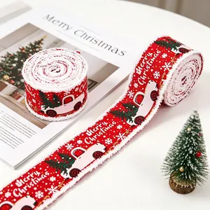 Detail of red Christmas ribbon with white truck prints and frayed edges for gift wrapping