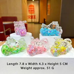 Detailed view showing five colorful motorcycle keychains with liquid sand and beads