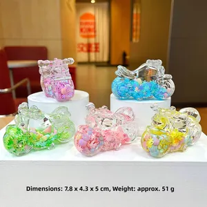 Detailed view showing five colorful motorcycle keychains with liquid sand and beads