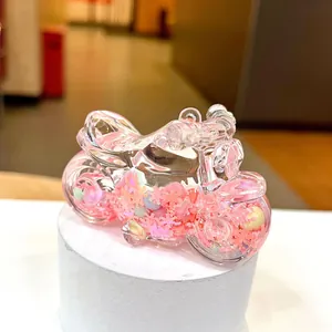 Close-up of pink motorcycle-shaped resin liquid glitter toy with floating sequins