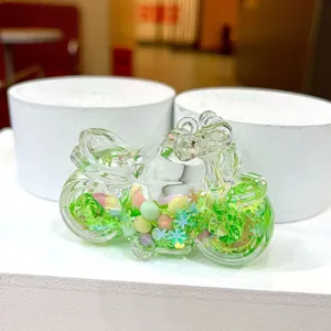 Detail of creative crystal sand motorcycle keychain with green snowflake glitter and liquid