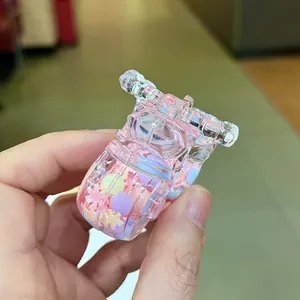 Detailed close-up of a pink acrylic motorcycle keychain with glitter and colorful beads