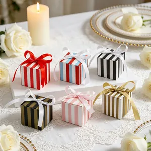 Detailed view of colorful striped gift boxes with silk ribbon bows for wedding favors