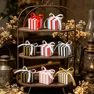 Detailed view of colorful striped gift boxes with satin ribbons on a vintage shelf