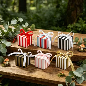Striped gift boxes with silk bows arranged on a rustic wooden bench with forest decor