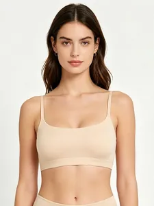 Detail of nude seamless wireless bra featuring wide elastic hem and thin straps