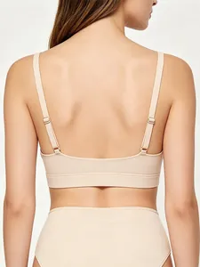 Close-up of seamless nude bra with adjustable straps and wide elastic back support band