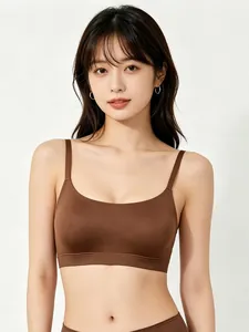 Close-up of seamless chocolate brown sports bra with thin straps and smooth elastic fabric