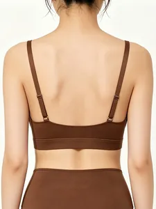 Detail of dark brown sports bra featuring adjustable thin straps and seamless wide hem