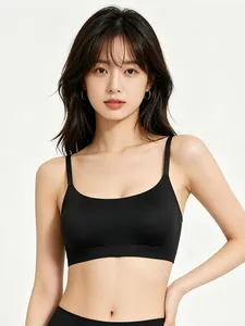 Close-up of black seamless scoop neck sports bra with thin shoulder straps on model