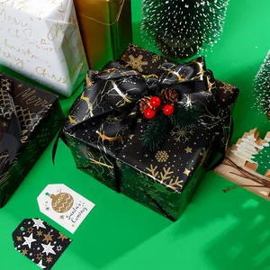 Premium black and gold Christmas wrapping paper set with snowflakes and festive ribbons