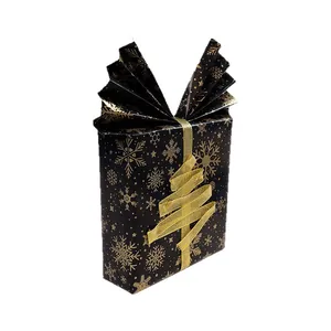 Black and gold Christmas gift wrap featuring snowflake patterns and a ribbon tree design