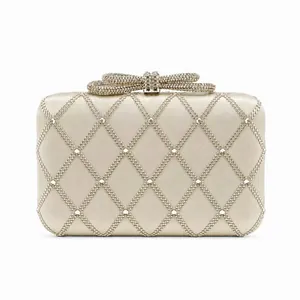Elegant champagne gold evening clutch bag with quilted pattern and pearl detailing
