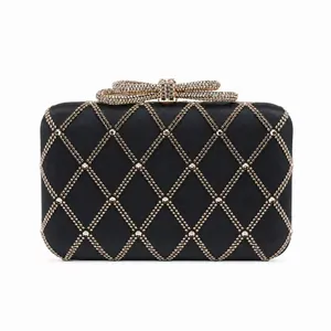 Elegant black evening clutch bag with gold rhinestone diamond pattern and bow clasp