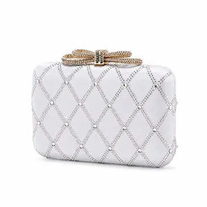 Macro detail of satin evening clutch with diamond lattice crystals and gold bow clasp