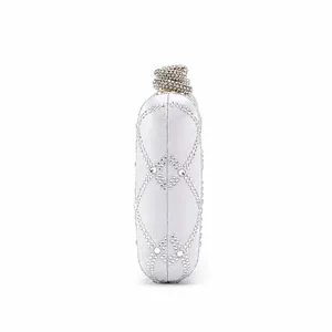 Macro view of white satin evening bag with rhinestone grid pattern and crystal clasp