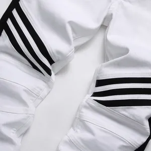 Slim fit white biker jeans with black stripes and knee paneling detail for men