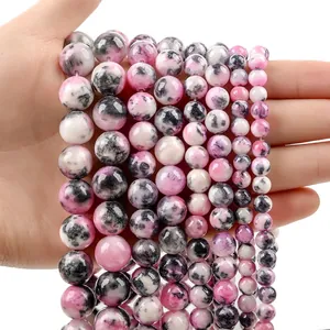 Macro detail of polished pink zebra jasper round beads in various diameter sizes