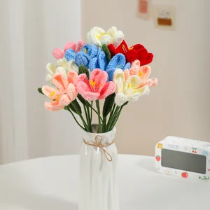 Handmade crochet tulip bouquet in a white ceramic vase with colorful knitted flowers