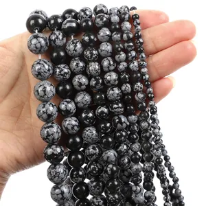 Detailed macro view of natural snowflake obsidian round beads with unique grey mineral patterns
