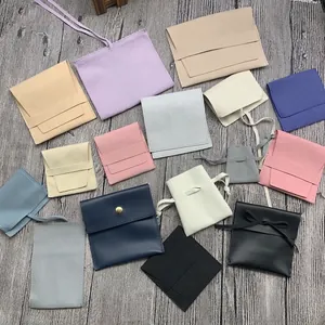 Detailed flat lay of colorful microfiber suede jewelry pouches with various closure styles