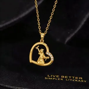 Detail of gold heart pendant with graduate silhouette and white zircon accents