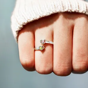 Macro detail of S925 sterling silver ring featuring double hearts and colorful zircons
