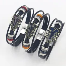 Detail of three braided leather guitar bracelets with colorful headstock charms