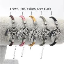 Braided leather bracelets in five colors with dreamcatcher feather charms on display stand