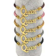 Detail of woven leather bracelets with gold Queen charms and crowns in five colors