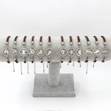 Detailed set of twelve zodiac signs braided leather bracelets on a T-bar display stand