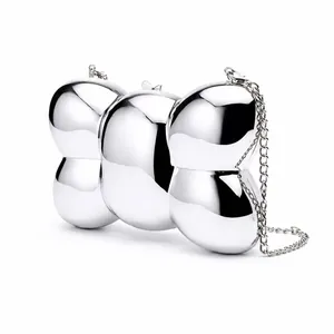 Silver bow-shaped metallic evening bag with mirror finish and slim chain strap