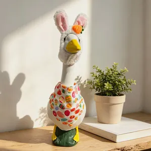 Detail of 23 inch white porch goose plush in Easter bunny outfit and egg pattern bib