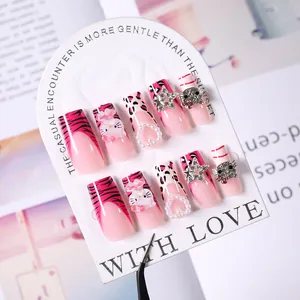 Pink and white press-on nails featuring Hello Kitty, leopard print, and 3D bow charms