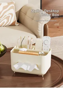 Macro view of cream-colored desktop tissue box featuring multi-slot storage and gold feet