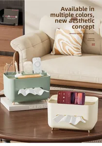 Detail of mint green tissue box with built-in remote control organizer and gold legs
