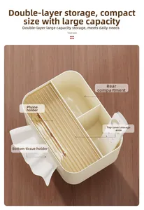 Close-up of cream tissue box featuring a built-in gold phone holder and remote storage
