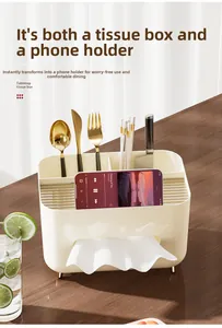 Cream-colored tissue box with gold feet and storage compartments for cutlery on wooden desk